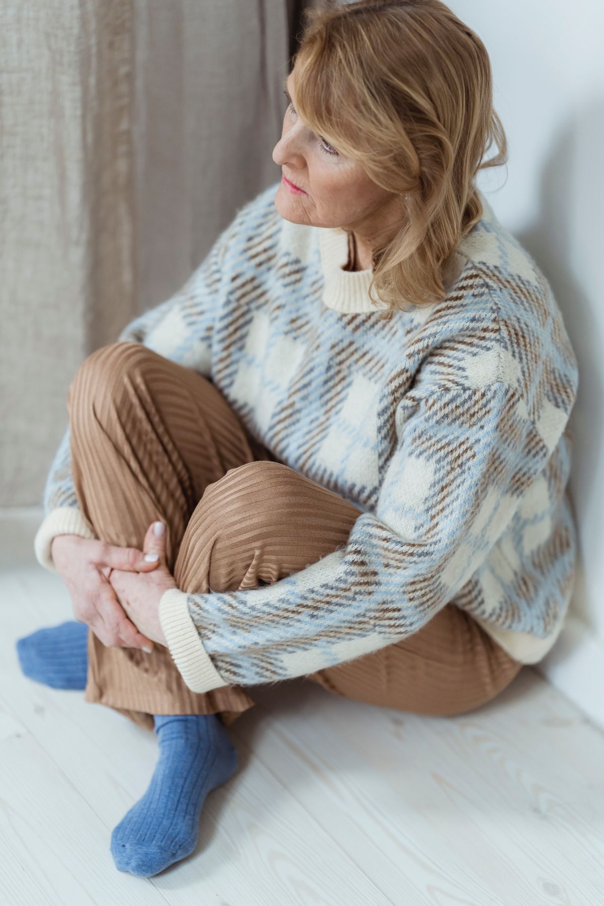 Woman alone, sitting with her thoughts, struggling with body frustration